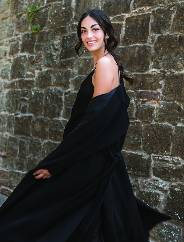 Woman wearing trench coat and smiling