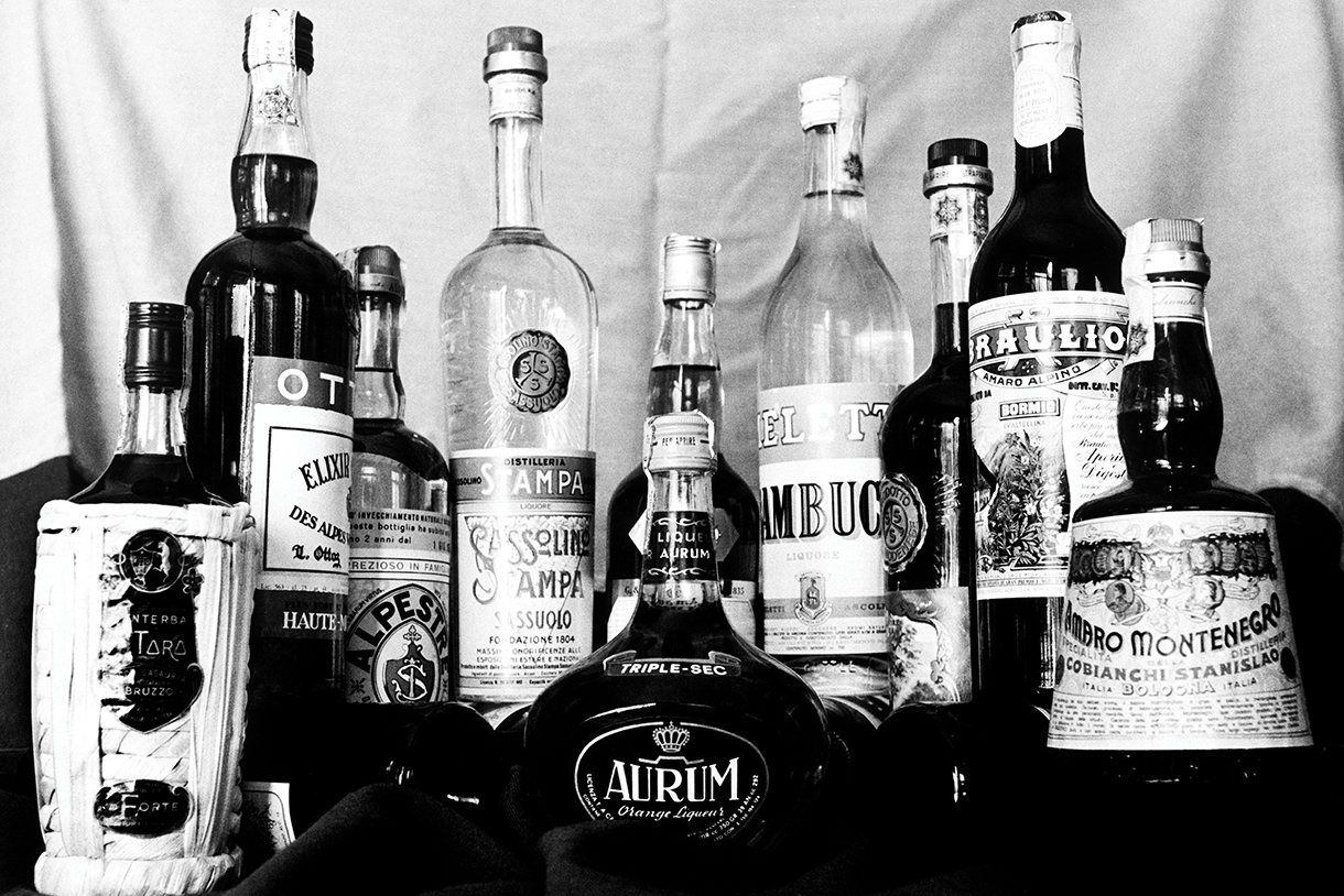 Black and white vintage photo of a variety of Italian bitters bottles