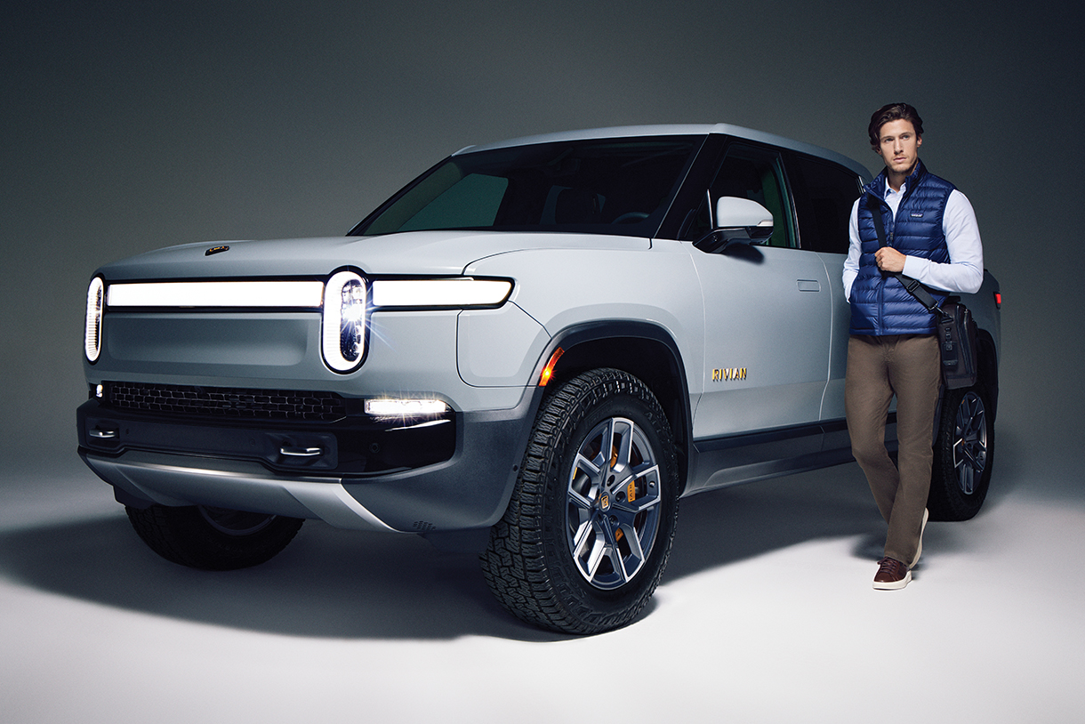 Man standing next to parked Rivian R1T