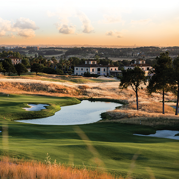 Golf course with beautiful lakes and greens. Country club in the background.