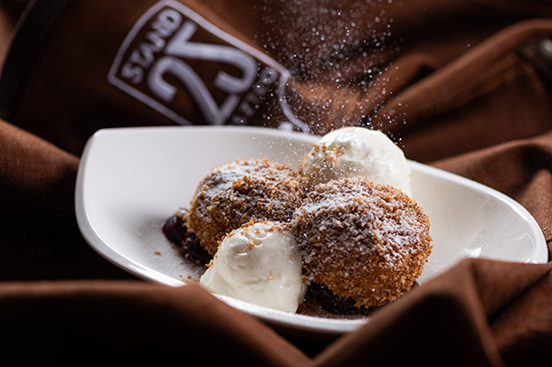 A Hungarian dessert, Turogomboc cottage cheese dumplings and sour cream foam served in a white bowl