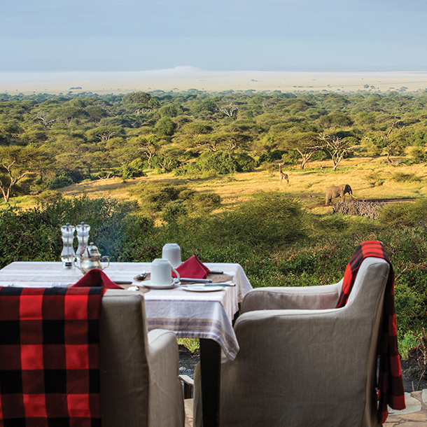 Outdoor dining table set up with view of Great Plains and wildlife