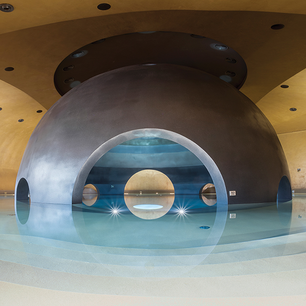 Interior of avant-garde sphere pool with dome-shaped stone walls