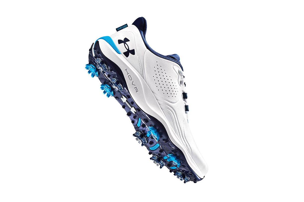 A close-up, side angle view of Under Armour UA Drive Pro Golf Shoes, featuring a white and blue color scheme with a prominent 