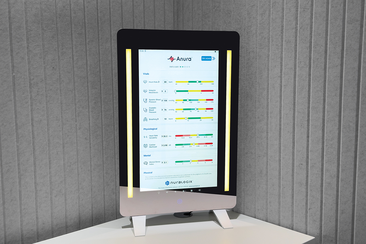 A smart mirror with a digital display showing various health metrics, including heart rate, blood pressure, and sleep quality. The mirror is standing on a white pedestal.